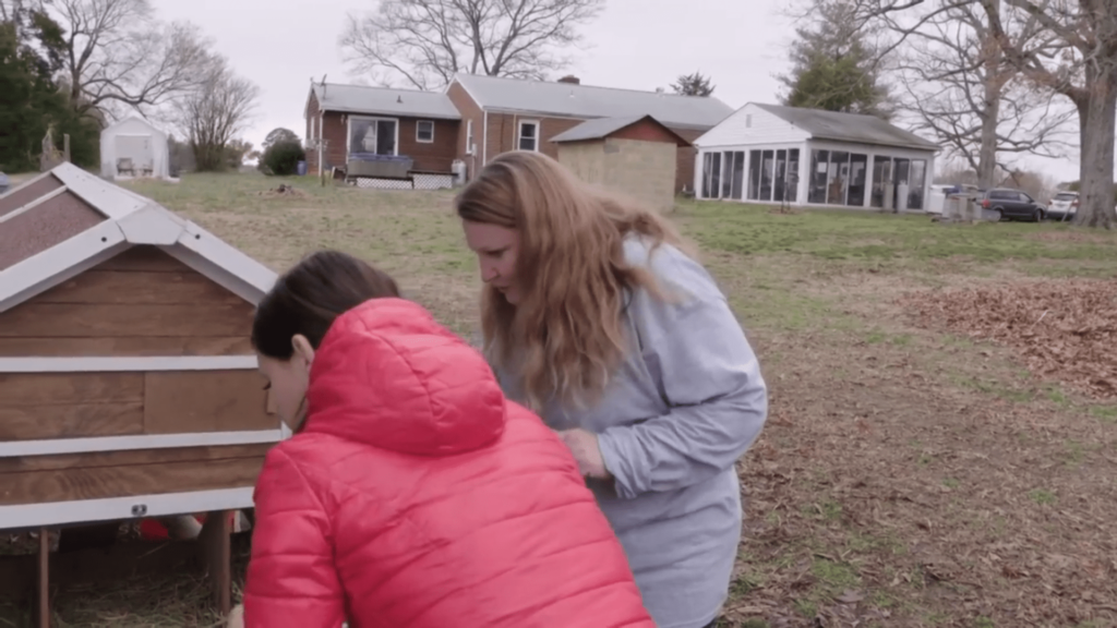 Aspen shows Julia Trubkina how to collect eggs