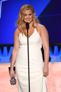 Amy Schumer Looking Gorgeous Talking Into a Microphone Photo
