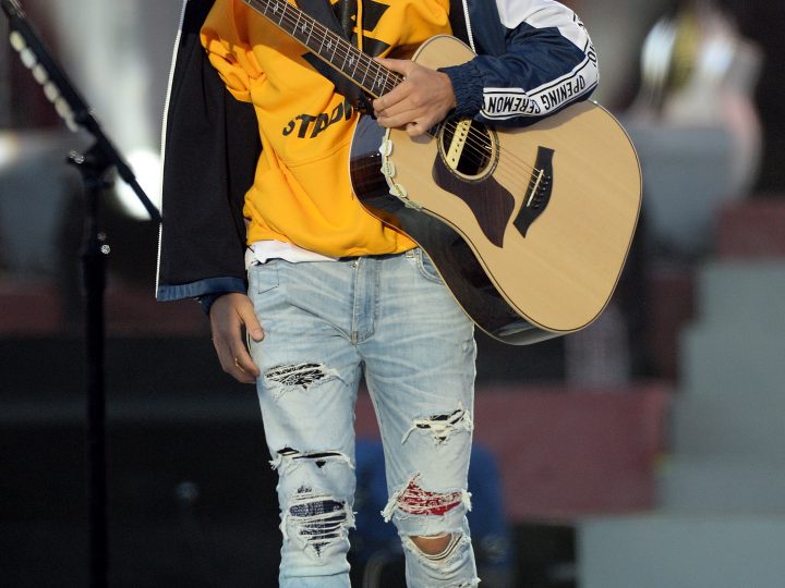 Justin Bieber Holds Guitar