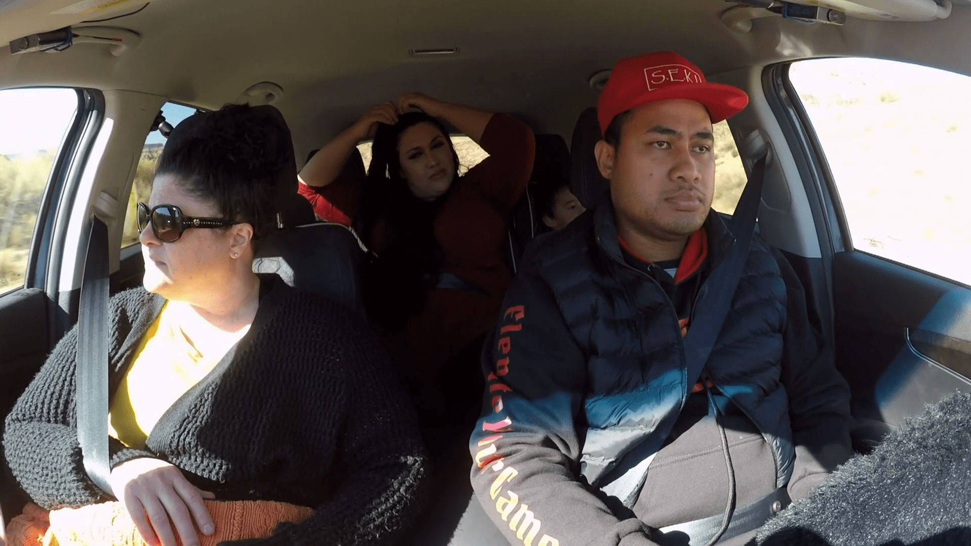 Kalani Faagata and Asuelu Pulaa and Kalani's mom in the car The