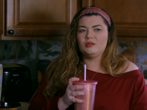 Amber Portwood holds a drink cup in her kitchen.