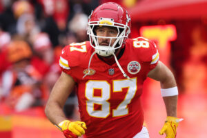 Travis Kelce runs onto the field.