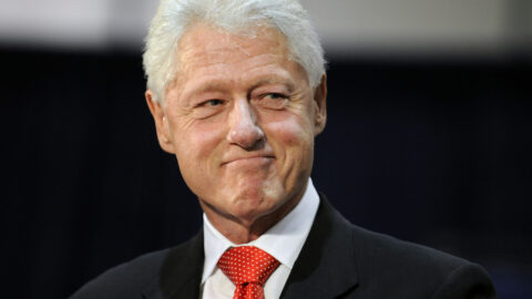 Bill Clinton smiles while attending a political rally.