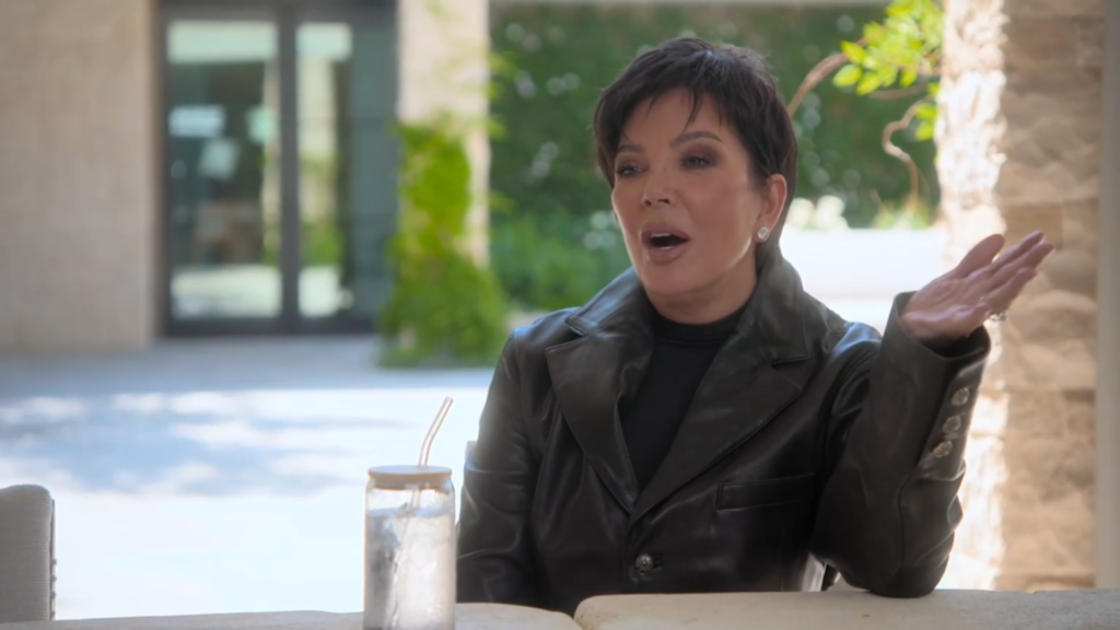 Kris Jenner speaks while seated at the table.