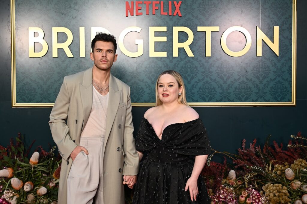 Luke Newton holding hands with Nicola Coughlan