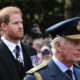 King Charles III and Britain's Prince Harry, Duke of Sussex walk behind the coffin of Queen Elizabeth II.