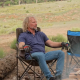 Kody Brown sits by an outdoor fire.