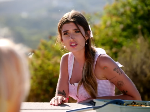 Sami Sheen looks beautiful but confrontational at a picnic table.