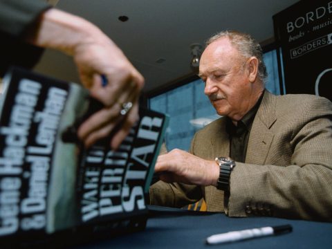 Actor Gene Hackman signs a copy of his new book 