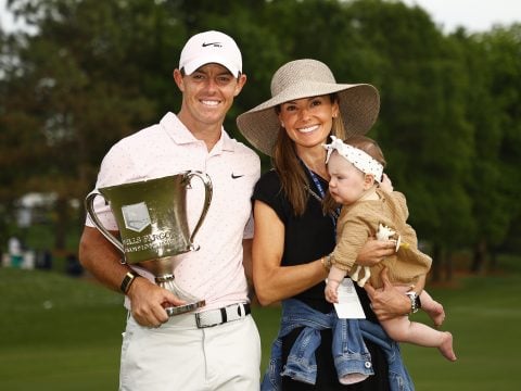 Rory McIlroy of Northern Ireland celebrates with the trophy alongside his wife Erica and daughter Poppy after winning during the final round of the 2021 Wells Fargo Championship at Quail Hollow Club on May 09, 2021 in Charlotte, North Carolina.