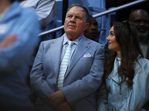 North Carolina Tar Heels football head coach Bill Belichick and his girlfriend Jordon Hudson look on during the first half of the game between the North Carolina Tar Heels and the Duke Blue Devils at Dean E. Smith Center on March 08, 2025 in Chapel Hill, North Carolina.