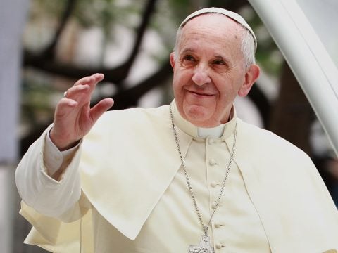 Pope Francis waves to thousands of followers as he arrives at the Manila Cathedral on January 16, 2015 in Manila, Philippines.