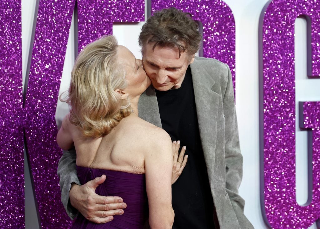 Pamela Anderson kisses Liam Neeson on July 22, 2025.