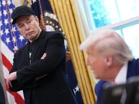 Tesla CEO Elon Musk listens as U.S. President Donald Trump speaks to reporters in the Oval Office of the White House on May 30, 2025 in Washington, DC.