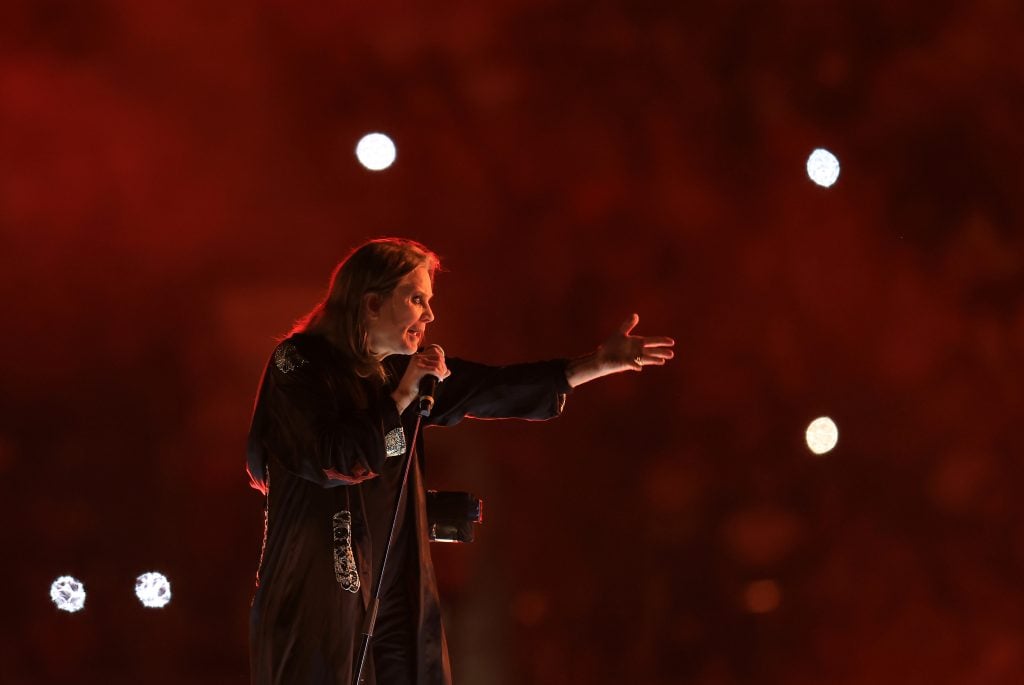 Ozzy Osbourne with a red background in August 2022.