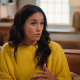 Meghan Markle in a yellow blouse while chatting.