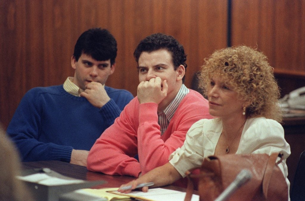 Erik Menendez (C) and his brother Lyle (L) are pictured, on August 12, 1991 in Beverly Hills. They are accused of killing their parents, Jose and Mary Louise Menendez of Beverly Hills, Calif. 