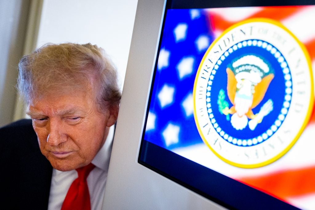 U.S. President Donald Trump takes a question from a reporter aboard Air Force One on August 15, 2025, in flight. President Trump is traveling to Anchorage, Alaska, for peace talks with Russian President Vladimir Putin on the war with Ukraine. 
