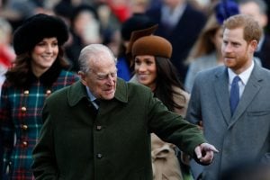 Britain's Prince Philip, Duke of Edinburgh (C) gestures as he is followed by (L-R) Britain's Catherine, Duchess of Cambridge, US actress and fiancee of Britain's Prince Harry Meghan Markle and Britain's Prince Harry arriving to attend the Royal Family's traditional Christmas Day church service at St Mary Magdalene Church in Sandringham, Norfolk, eastern England, on December 25, 2017.