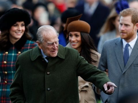 Britain's Prince Philip, Duke of Edinburgh (C) gestures as he is followed by (L-R) Britain's Catherine, Duchess of Cambridge, US actress and fiancee of Britain's Prince Harry Meghan Markle and Britain's Prince Harry arriving to attend the Royal Family's traditional Christmas Day church service at St Mary Magdalene Church in Sandringham, Norfolk, eastern England, on December 25, 2017.