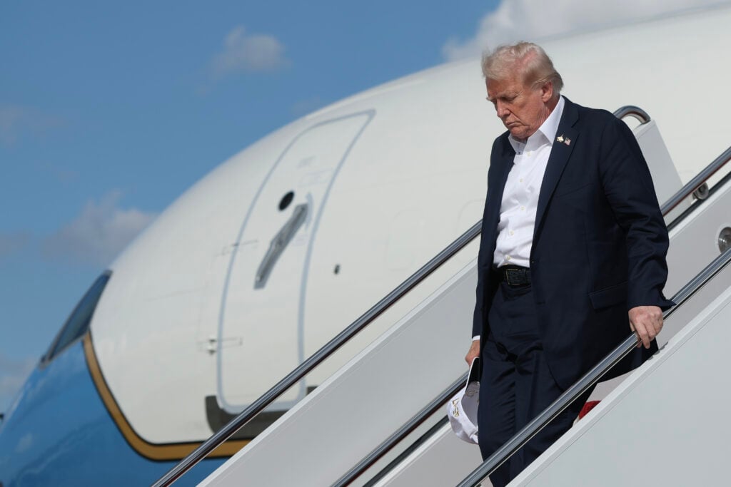 Donald Trump delicately walks down the stairs.