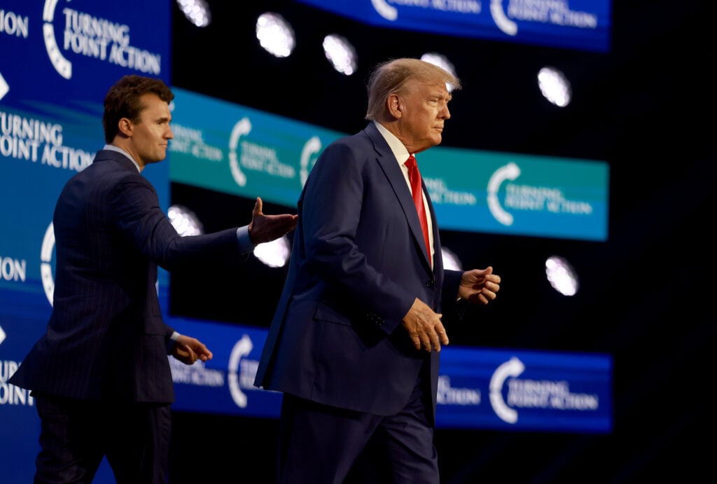 Former US President Donald Trump walks on stage after being introduced by Charlie Kirk (L) at the Turning Point Action conference as he continues his 2024 presidential campaign on July 15, 2023 in West Palm Beach, Florida.