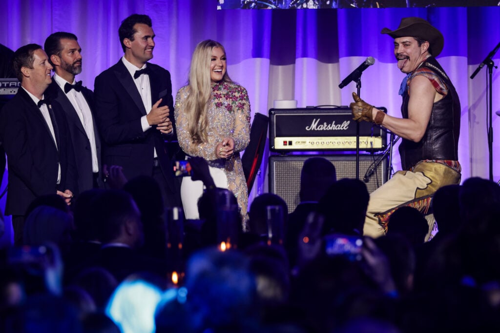 Sergio Gor, Donald Trump Jr., Charlie Kirk, and Erika Frantzve watch on stage as The Village People perform YMCA during the Turning Point USA Inaugural-Eve Ball at the Salamander Hotel on January 19, 2025 in Washington, DC.