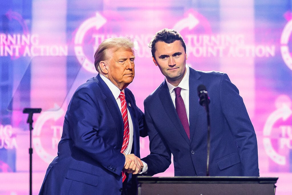 US right-wing activist Charlie Kirk speaks on stage with President Donald Trump at America Fest 2024 in Phoenix, Arizona, on December 22, 2024.