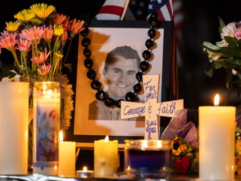 Candles and flowers are seen near a portrait of right-wing activist Charlie Kirk at a makeshift memorial during a candlelight vigil at Memorial Park in Provo, Utah, on September 12, 2025, after he was shot during a public event at Utah Valley University.