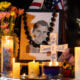Candles and flowers are seen near a portrait of right-wing activist Charlie Kirk at a makeshift memorial during a candlelight vigil at Memorial Park in Provo, Utah, on September 12, 2025, after he was shot during a public event at Utah Valley University.