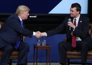U.S. President Donald Trump shakes hands with conservative activist Charlie Kirk at a forum dubbed the Generation Next Summit at the White House on March 22, 2018 in Washington, DC.