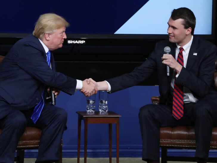 U.S. President Donald Trump shakes hands with conservative activist Charlie Kirk at a forum dubbed the Generation Next Summit at the White House on March 22, 2018 in Washington, DC.