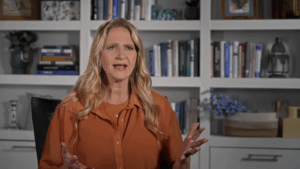 Christine Brown gestures at the camera.