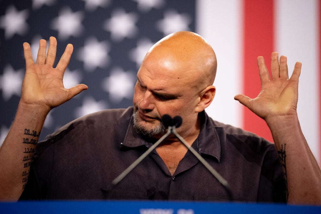 Sen. John Fetterman (D-PA) gestures while speaking at a rally for Democratic vice presidential nominee Minnesota Gov. Tim Walz at York Exposition Center UPMC Arena on October 2, 2024 in York, Pennsylvania.
