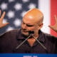Sen. John Fetterman (D-PA) gestures while speaking at a rally for Democratic vice presidential nominee Minnesota Gov. Tim Walz at York Exposition Center UPMC Arena on October 2, 2024 in York, Pennsylvania.