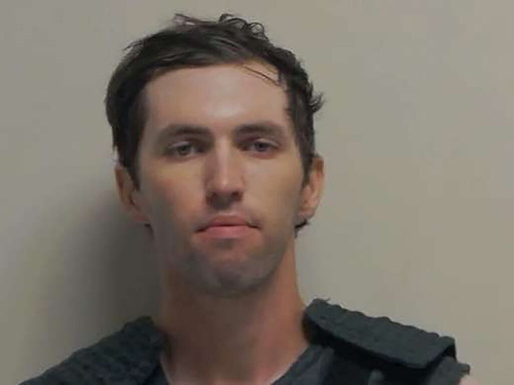 In this handout image provided by the Office of the Governor of Utah, Tyler Robinson stands for a booking photo on September 12, 2025 in Spanish Fork, Utah.