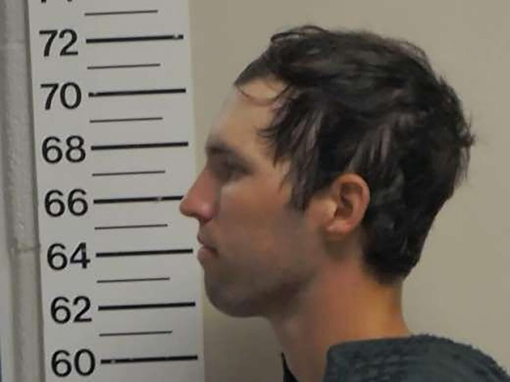 In this handout image provided by the Office of the Governor of Utah, Tyler Robinson stands for a booking photo on September 12, 2025 in Spanish Fork, Utah.