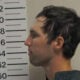 In this handout image provided by the Office of the Governor of Utah, Tyler Robinson stands for a booking photo on September 12, 2025 in Spanish Fork, Utah.