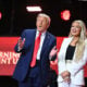 US President Donald Trump reacts next to Erika Kirk, widow of Charlie Kirk, after speaking at the public memorial service for right-wing activist Charlie Kirk at State Farm Stadium in Glendale, Arizona, on September 21, 2025.