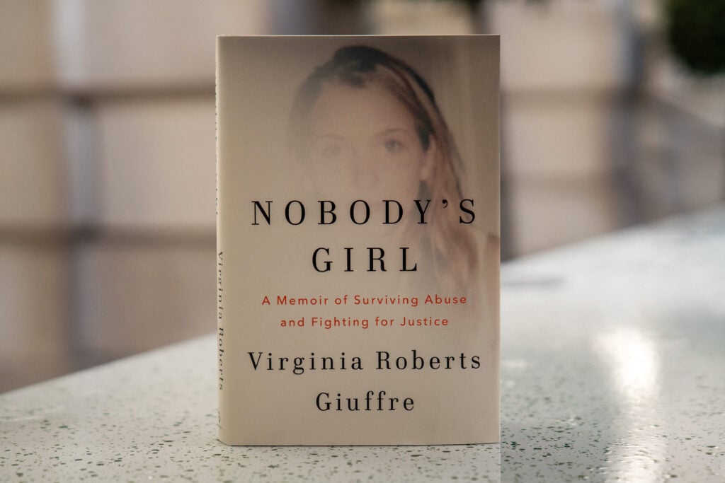 A copy of the book "Nobody's Girl - A Memoir of Surviving Abuse and Fighting for Justice" by Virginia Roberts Giuffre, is pictured in central London on October 21, 2025, on the day of its release in the UK.