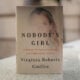 A copy of the book "Nobody's Girl - A Memoir of Surviving Abuse and Fighting for Justice" by Virginia Roberts Giuffre, is pictured in central London on October 21, 2025, on the day of its release in the UK.