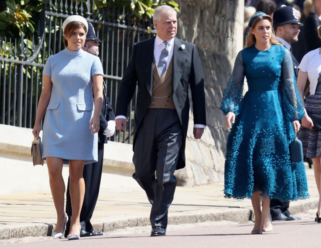 Britain's Prince Andrew, Duke of York, and his daughters Britain's Princess Eugenie of York (L) and Britain's Princess Beatrice of York arrive for the wedding ceremony of Britain's Prince Harry, Duke of Sussex and US actress Meghan Markle at St George's Chapel, Windsor Castle, in Windsor, on May 19, 2018.