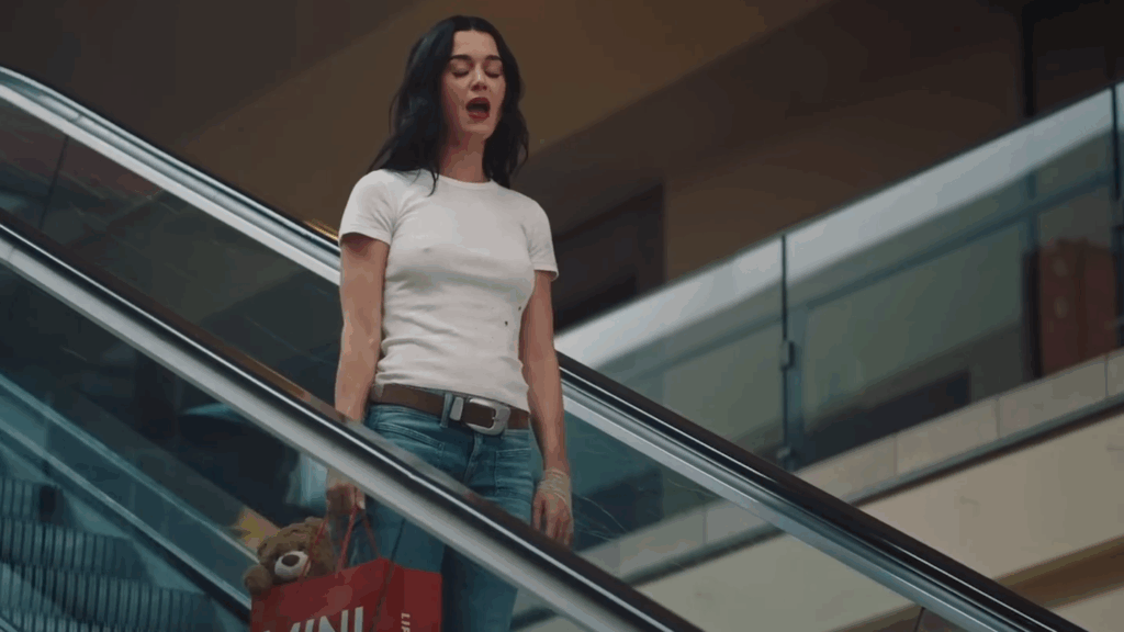 Katy Perry sings sadly on on escalator in the "Bandaids" music video.