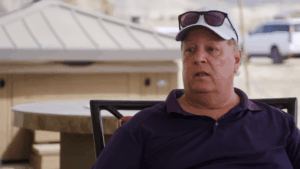 Chuck Potthast on 90 Day Fiance wearing his hat and glasses.