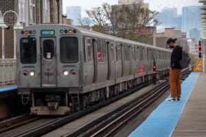 Passengers wait to board an "L" train at a station on November 09, 2021 in Chicago, Illinois.