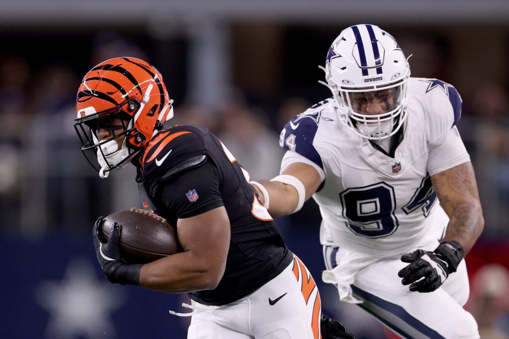 Khalil Herbert #34 of the Cincinnati Bengals runs the ball against Marshawn Kneeland #94 of the Dallas Cowboys during the second quarter in the game at AT&T Stadium on December 09, 2024 in Arlington, Texas.