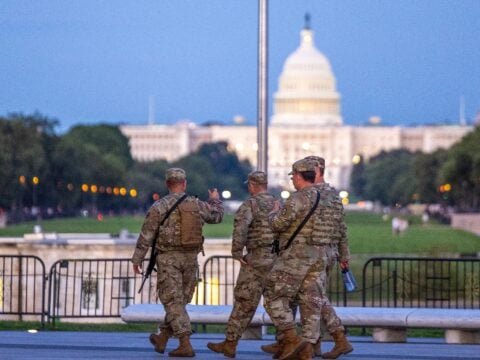 National Guard members patrol carrying weapons with the U.S. Capitol Building in the distance on August 25, 2025 in Washington, DC.