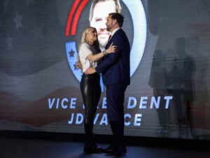 Erika Kirk, widow of Turning Point USA founder Charlie Kirk, and U.S. Vice President JD Vance embrace on stage during a Turning Point USA event at the Pavilion at Ole Miss at the University of Mississippi, on October 29, 2025 in Oxford, Mississippi.