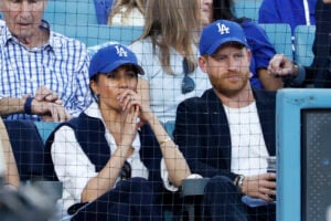 Prince Harry, Duke of Sussex and Meghan, Duchess of Sussex look on from the stands during game four of the 2025 World Series between the Toronto Blue Jays and the Los Angeles Dodgers at Dodger Stadium on October 28, 2025 in Los Angeles, California.