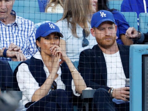 Prince Harry, Duke of Sussex and Meghan, Duchess of Sussex look on from the stands during game four of the 2025 World Series between the Toronto Blue Jays and the Los Angeles Dodgers at Dodger Stadium on October 28, 2025 in Los Angeles, California.
